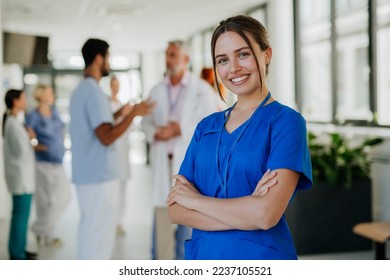 Portrait of young woman nurse at hospital corridor. - Shutterstock ID 2237105521