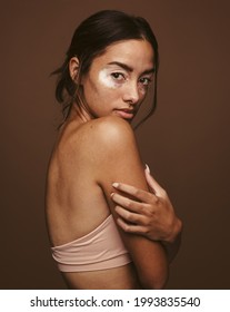 Portrait Of Young Woman On Brown Background. Close Up Of Confident Woman With Vitiligo.