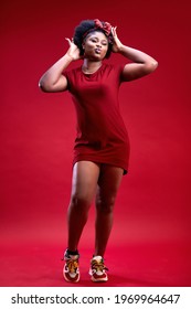 Chubby African American lady in sportswear performing leg warm up