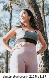 Portrait Of A Young Woman Outdoors On Sport Clothes Looking Away From Camera. Carefree, Positive And Freedom Concept. Healthy Lifestyle Doing Exercise Outdoors. Super Smile With Confident Attitude