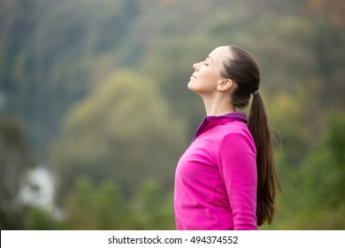 Portrait of a young woman outdoors in a sportswear, head up, her eyes closed. Concept photo, copy space