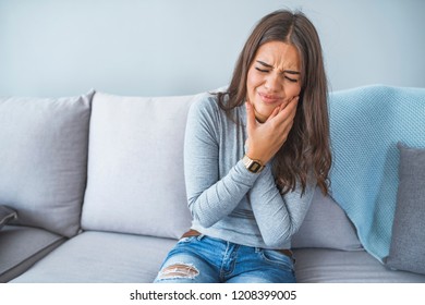 Portrait Of A Young Woman In Pain With A Toothache. Poor Lady Suffering From Severe Tooth Pain. Young Woman Has Toothache. Concept For Healthy Care