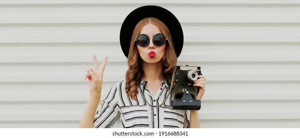 Portrait of young woman photographer with vintage film camera on a white background - Powered by Shutterstock