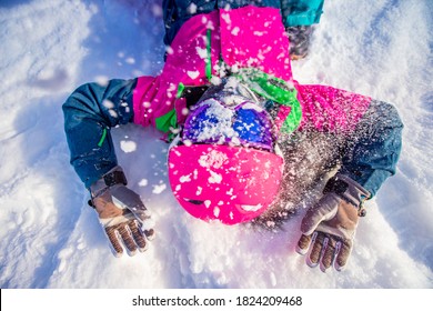 Portrait Young Woman In Pink Ski Helmet And Safety Glasses After Fall, Snow Dust.