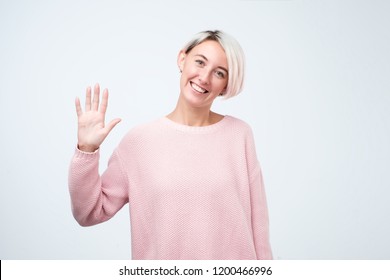 Portrait Of A Young Woman In Pink Sweater Smiling And Saying Hello. I Am So Glad To See You