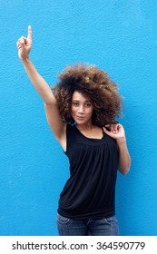 Portrait Of Young Woman Pointing Finger Up