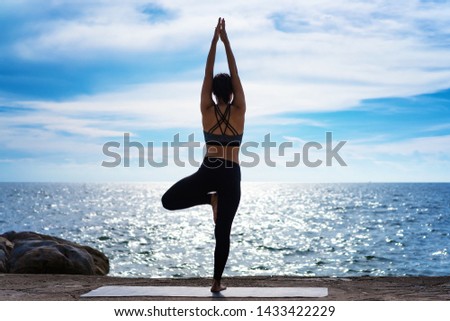 Portrait of young woman practicing yoga at the sea.Relax at the sea.Meditation