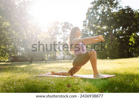 Portrait of young woman practicing yoga in park. Sport, Active life, healthy lifestyle.