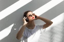 Portrait Of Young Woman With Red Lips Listening Music With Headphones