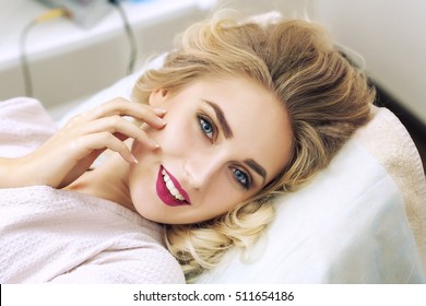 Portrait of a young woman relaxing in spa in bathrobe