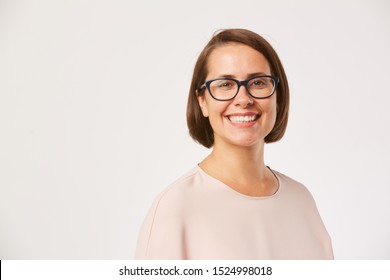 Portrait Of Young Woman With Short Hair And In Eyeglasses Smiling At Camera Isolated On White Background