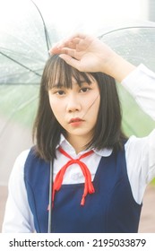 Portrait Of Young Woman Short Hair Wear Japanese Student High School Uniform With Umbrella Under Rain Drop.