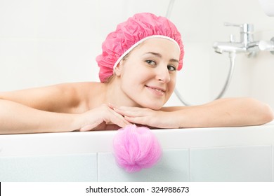 Portrait Of Young Woman In Shower Cap Posing In Bath