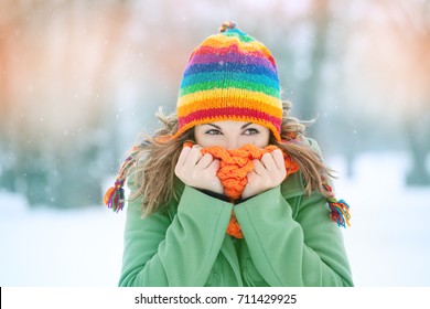 Portrait Of A Young Woman In Snow  With Scarf On Her Face Trying To Warm Herself. Winter Concept