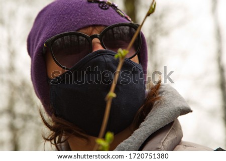 Portrait of a young woman in a spring forest during a pandemic.