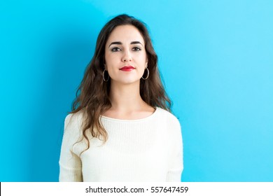 Portrait Of A Young Woman Standing Against A Solid Background