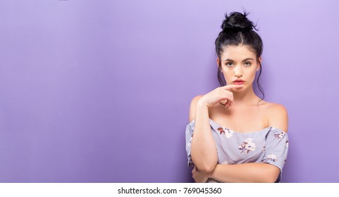 Portrait Of A Young Woman Standing Against A Solid Background