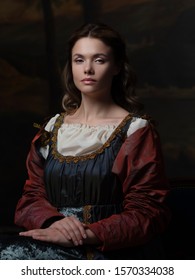 Portrait Of A Young Woman In The Style Of A Renaissance Painting. Beautiful Mysterious Girl In Medieval Dress