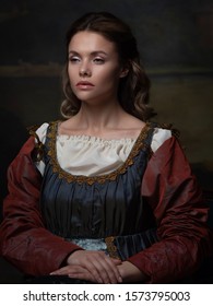 Portrait Of A Young Woman In The Style Of A Renaissance Painting. Beautiful Mysterious Girl In Medieval Dress