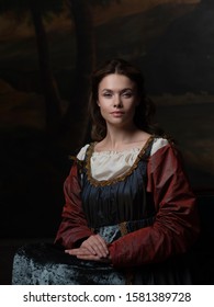 Portrait Of A Young Woman In The Style Of A Renaissance Painting. Beautiful Mysterious Girl In Medieval Dress