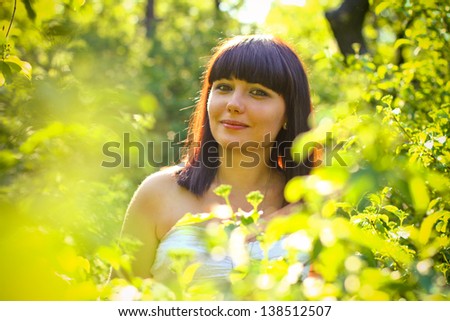 Portrait of young woman in  summer park