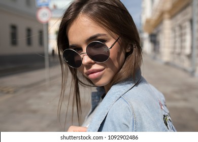 Portrait of a young woman in sunglasses.