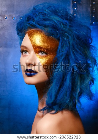Portrait of young woman in superhero cosmetics. studio shot