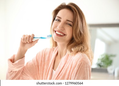 Portrait Of Young Woman With Toothbrush In Bathroom. Personal Hygiene