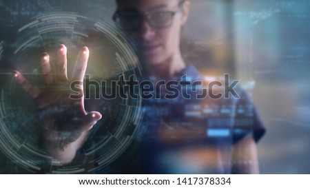 Portrait of an young woman is using the futuristic latest innovation technology with augmented reality hologram. Concept of future, innovation, technology, holographic