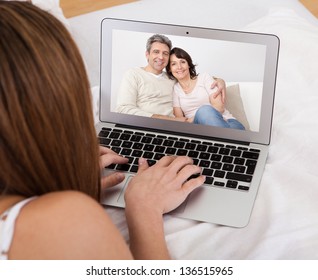 Portrait Of Young Woman Video Chatting With Parents - Powered by Shutterstock