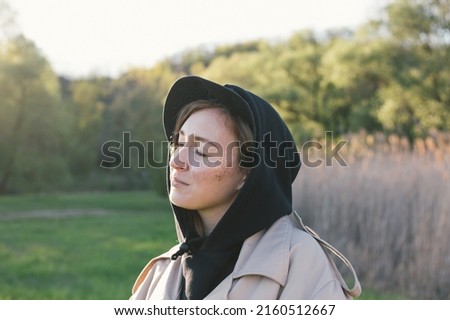 portrait of a young woman walking in the park