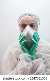 Portrait Of Young Woman Wearing Full Protective Gear, Respirator Mask And Goggles During Virus Outbreak