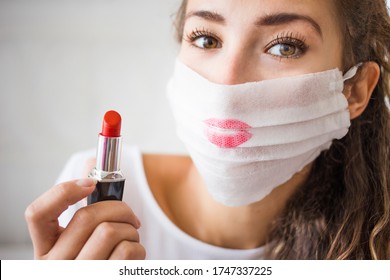 portrait of young woman wearing medical face mask during coronavirus. Make up problem and epidemy. Red lipstick on the protection mask. 