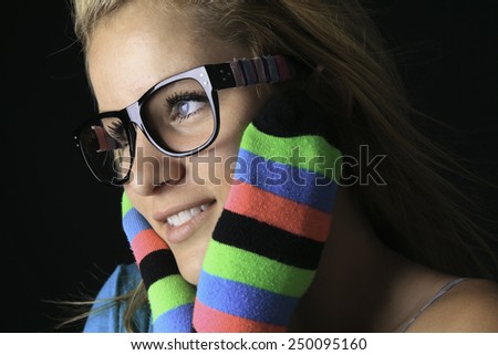 Portrait of young woman wearing striped multicolored socks isolated on white