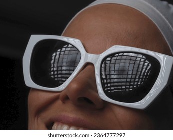 portrait of a young woman wearing sunglasses and a towel on her head - Shutterstock ID 2364777297