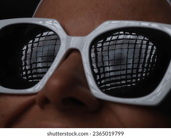 portrait of a young woman wearing sunglasses and a towel on her head - Shutterstock ID 2365019799