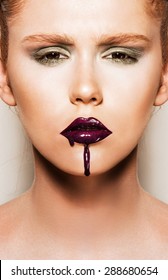 Portrait Of Young Woman Wearing Vogue Style Makeup. Beautiful Full Lips With Too Much Lipgloss Applied. 