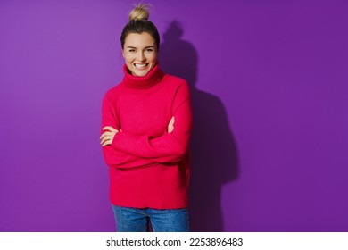 Portrait of young woman wearing warm and cozy polo neck sweater against purple background - Shutterstock ID 2253896483