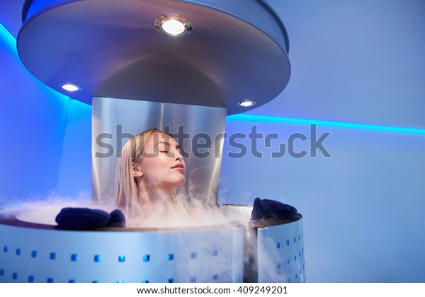 Portrait of young\
woman in a whole body cryo sauna. Female getting cryo therapy at\
the cosmetology\
clinic.