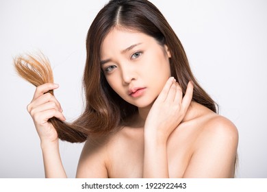 Portrait Of Young Woman Worried About Her Frizzy Hair Isolated On White Background