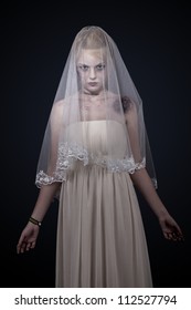 Portrait Of Zombie Bride Looked Scary And Standing At Dark Background. Shot In Studio