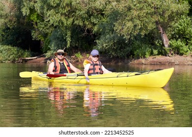 Portraits A Middle Age Couple Kayaking In A Tandem Kayak In Danube River At Summer Morning