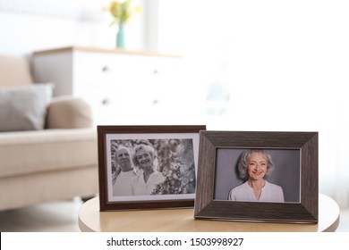 Portraits in stylish frames on table indoors - Shutterstock ID 1503998927