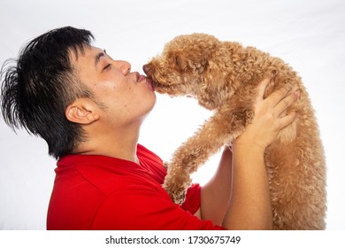 Portraiture Happy Asian Chinese Man With Joyful Puppy Purebred Toy Poodle Puppy On White Background. 