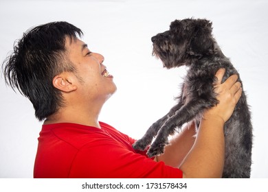 Portraiture Happy Asian Chinese Man With Joyful Puppy Purebred Toy Poodle Puppy On White Background. 