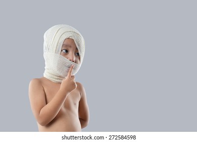 Portraiture Of Kid Wearing Medical Bandages.