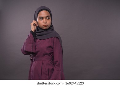 Portraiture of Muslim Girl wearing hijab.Angry face reaction.