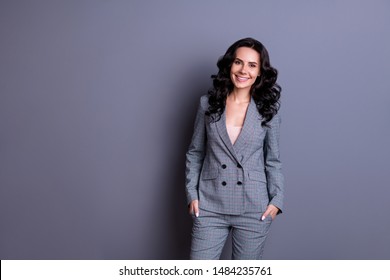 Portraut Of Beautiful Woman With Beaming Smile Standing Wearing Gray Suit Trousers Pants Isolated Over Gray Background