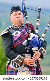 PORTREE, SCOTLAND - JULY 30, 2015: Man Playing Bag Pipes In Traditional Custome