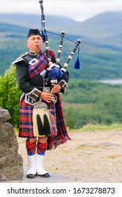 PORTREE, SCOTLAND - JULY 30, 2015: Man Playing Bag Pipes In Traditional Custome